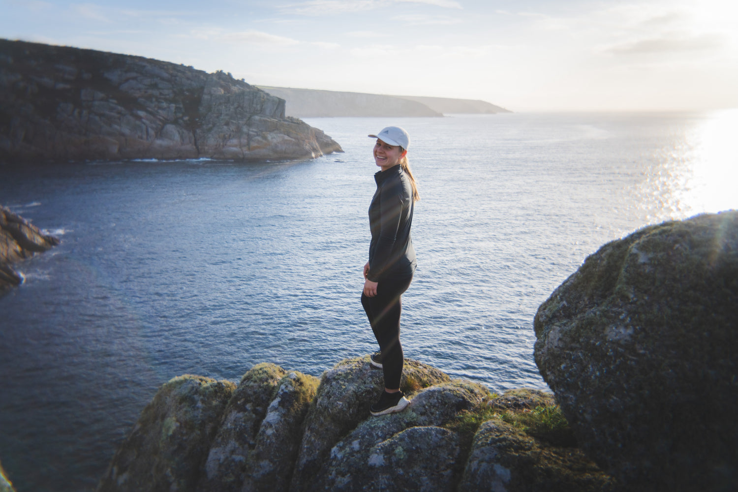 Founder yelena overlooking the sea at sunrise.