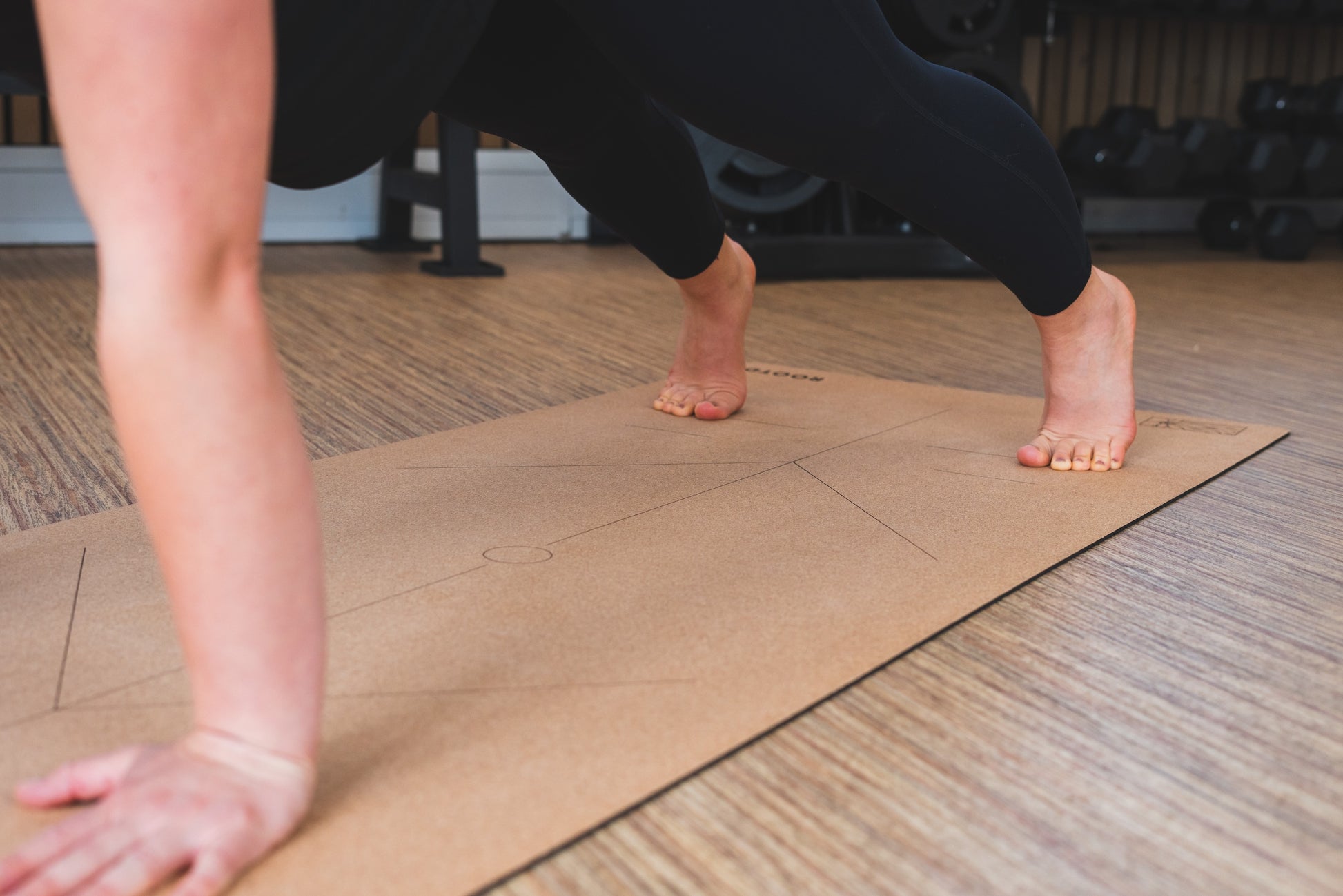 ROOTD Elite Align Design. Non-toxic eco cork exercise mat with alignment lines in a gym setting.