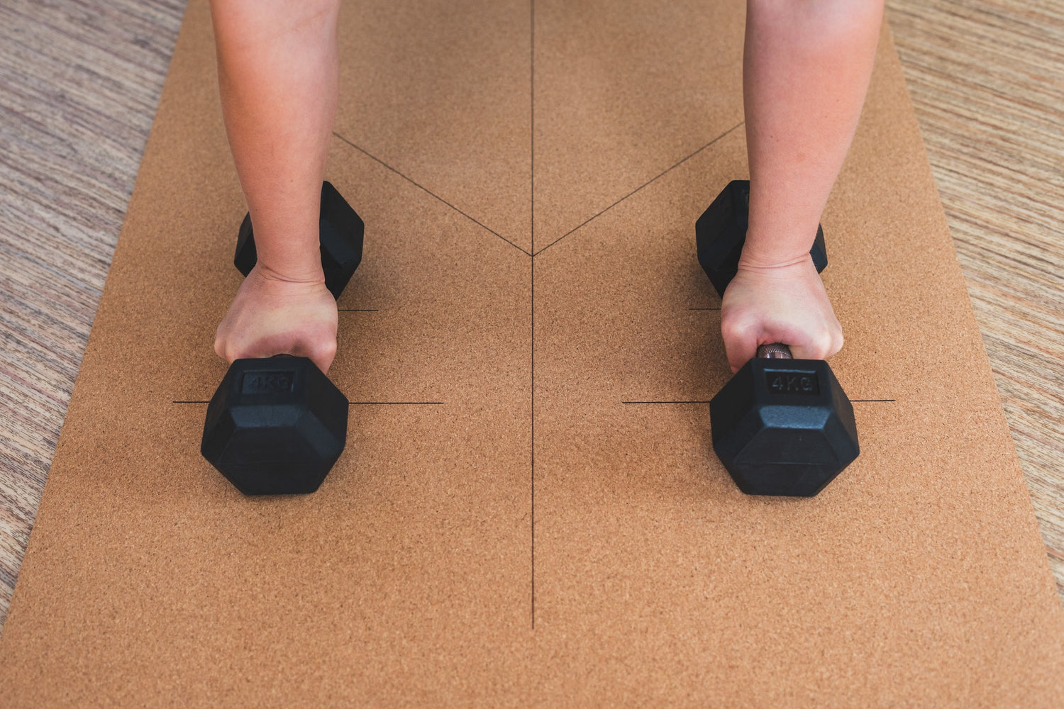 ROOTD Elite Elite Align Design. Non-toxic eco cork exercise mat being used in a gym setting with dumbells and alignment lines